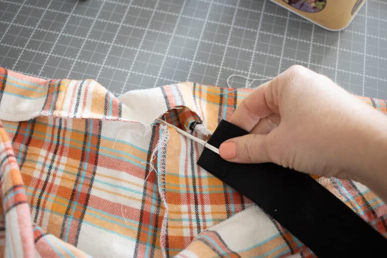 thread elastic through opening in waistband