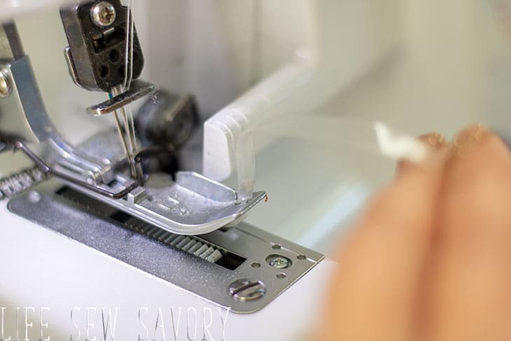 put the elastic into the serger foot