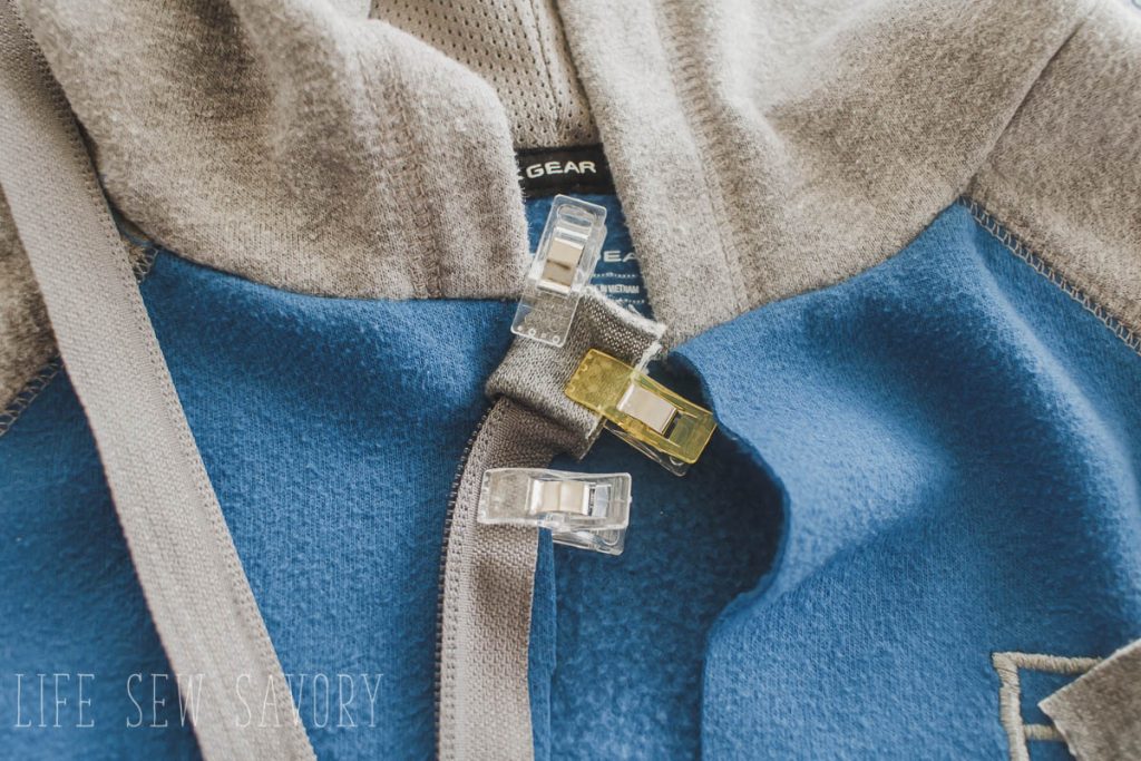 clip the zipper in place on the sweatshirt