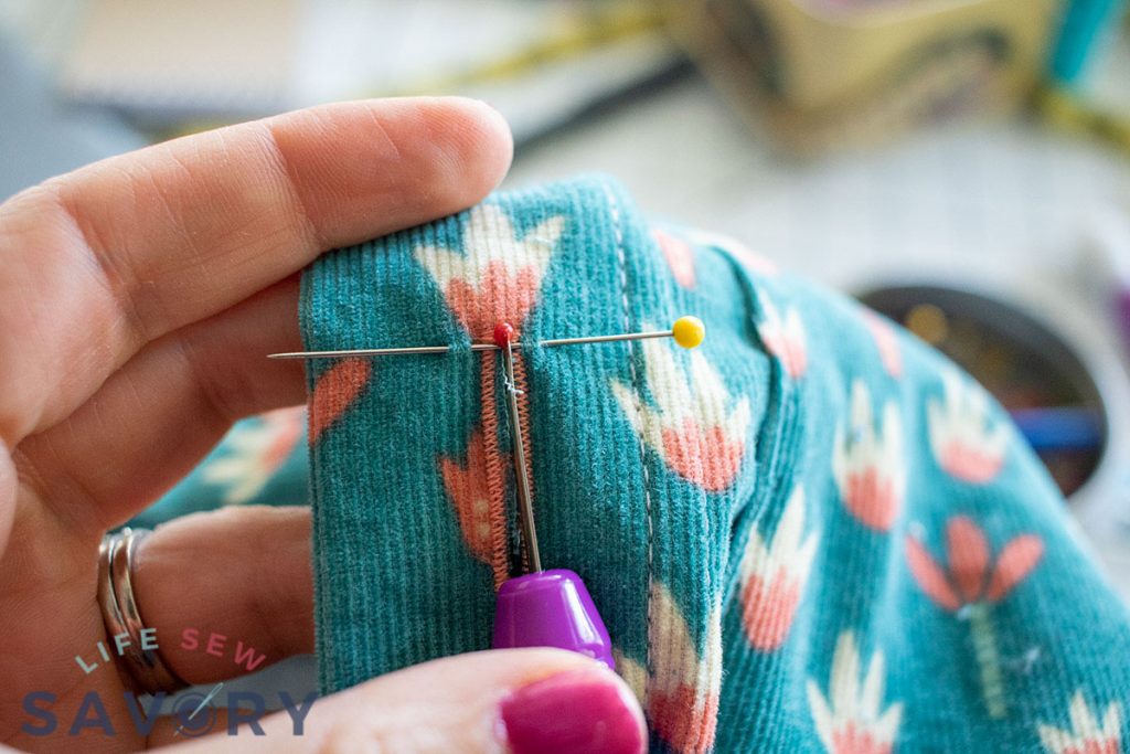 use a pin to cut the button hole