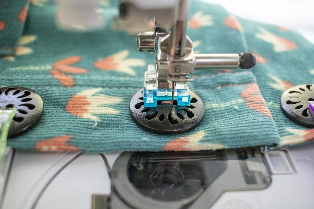 stitch slowly to secure the button
