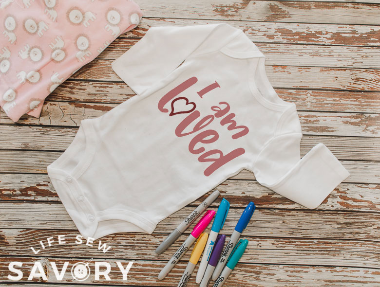 sign the baby onesie shower guest book