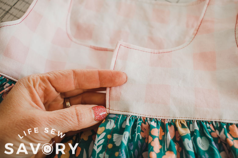 sew skirt to top then top stitch the seam allowance up