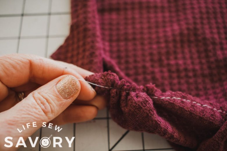 gather top of sleeve to fit the shoulder on the arm