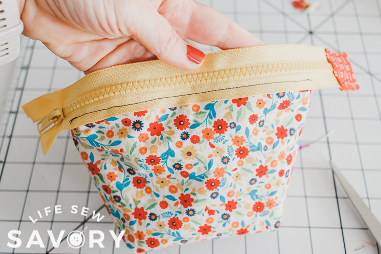 pouch with exposed zippers