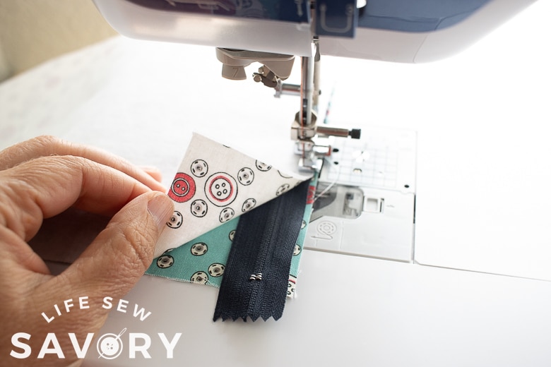 sew zipper between layers of fabric