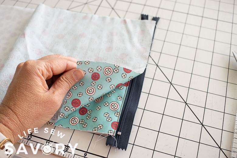 fold over fabric and match right sides attach to zipper
