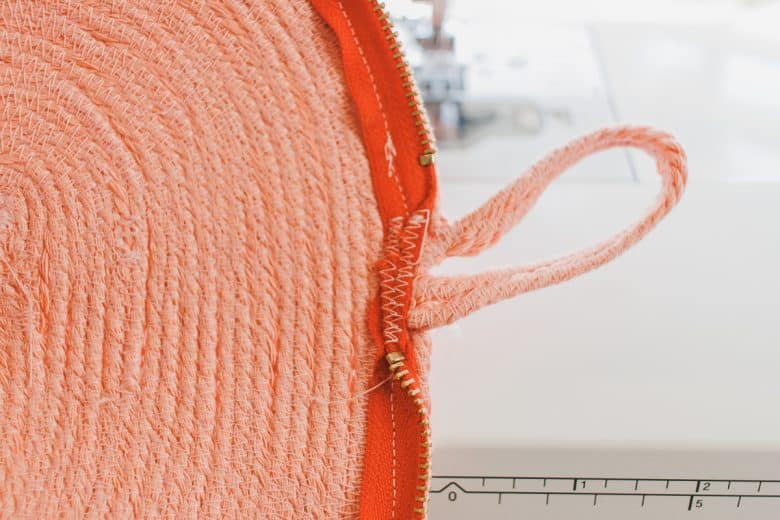 fold over strap and finish ends of zipper