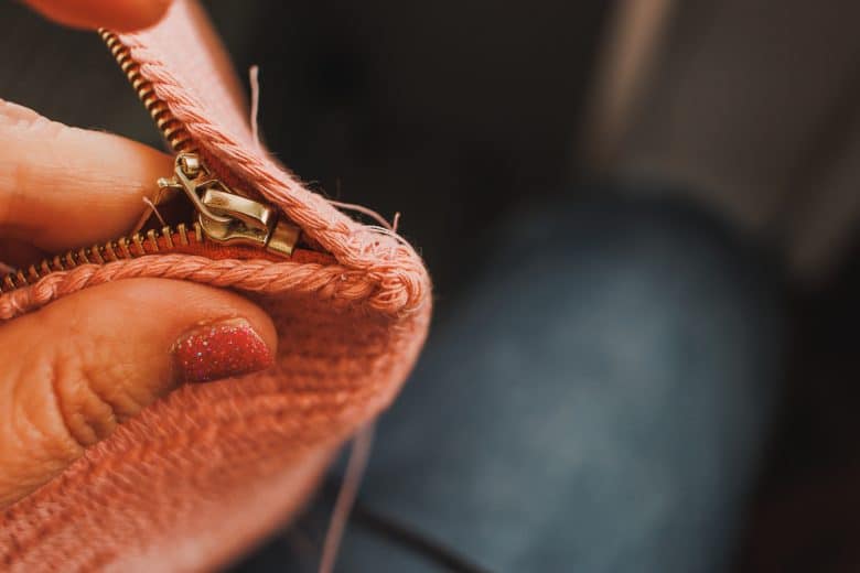 hand stitch end by zipper tab if needed