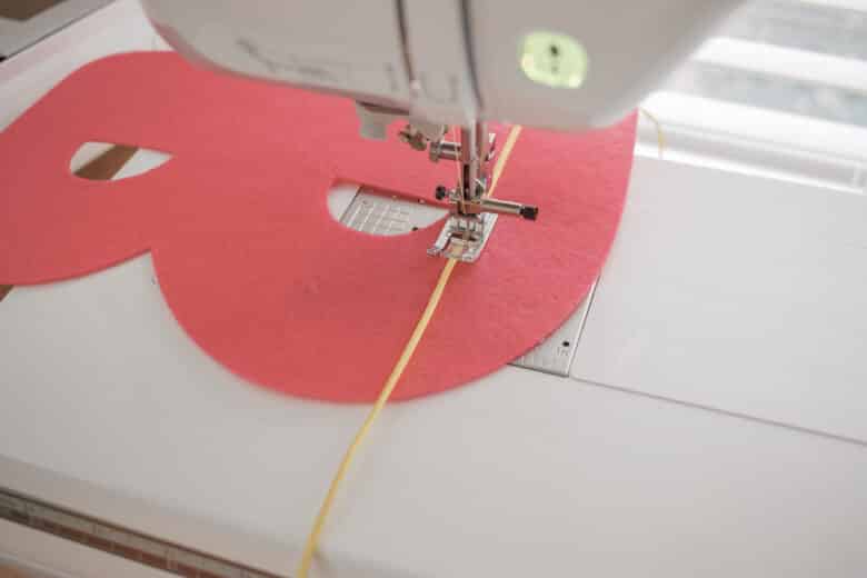 sew letters together with a zig-zag and cord