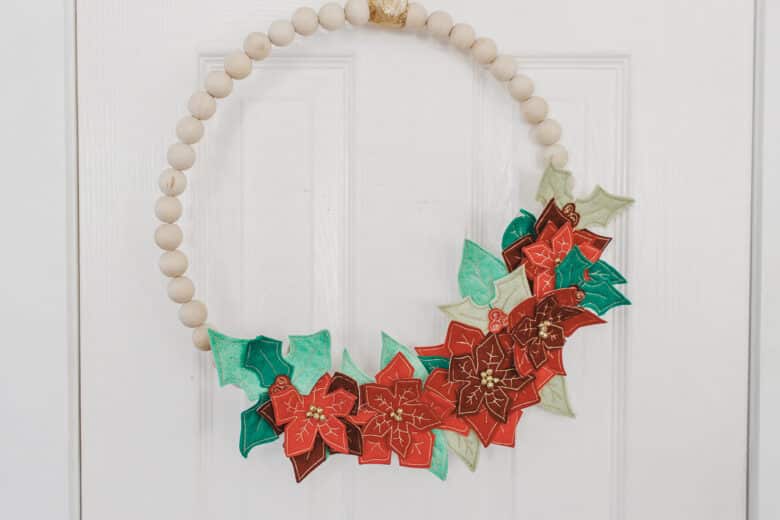 learn how to create a felt poinsettia wreath on your embroidery machine. Use the free template to create an embroidery file for your machine to sewn a beautiful felt Christmas wreath.