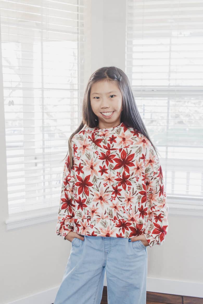 Find the details for the fabric and pattern used to create matching Christmas shirts for mom and daughter. The Surge Sweatshirt pattern is perfect for this project. I love sewing patterns that work for matching outfits.