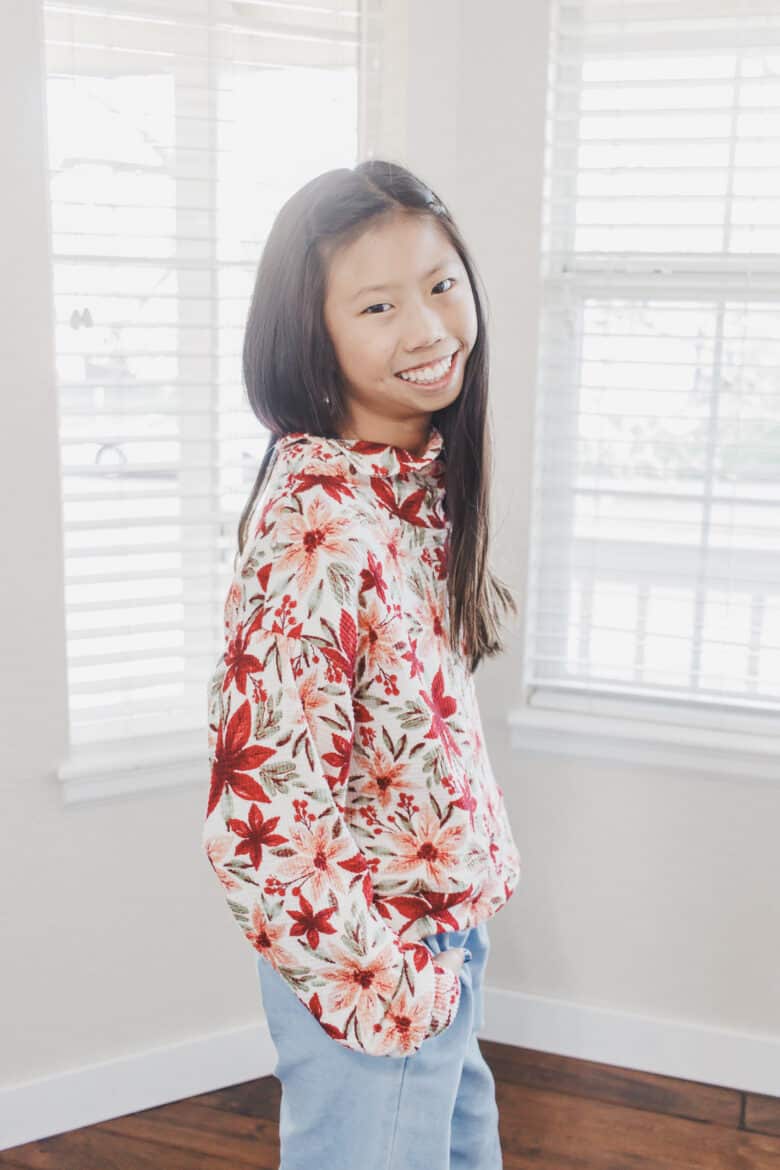 Find the details for the fabric and pattern used to create matching Christmas shirts for mom and daughter. The Surge Sweatshirt pattern is perfect for this project. I love sewing patterns that work for matching outfits.