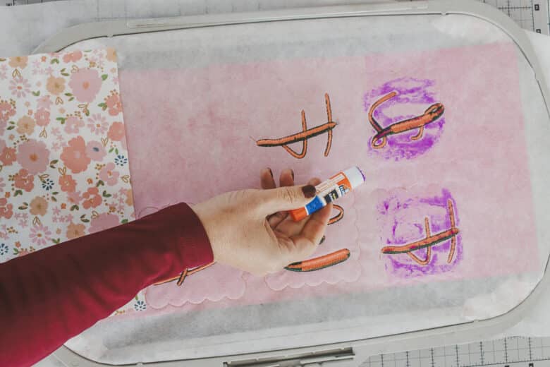 use fabric glue or glue stick on back of letters