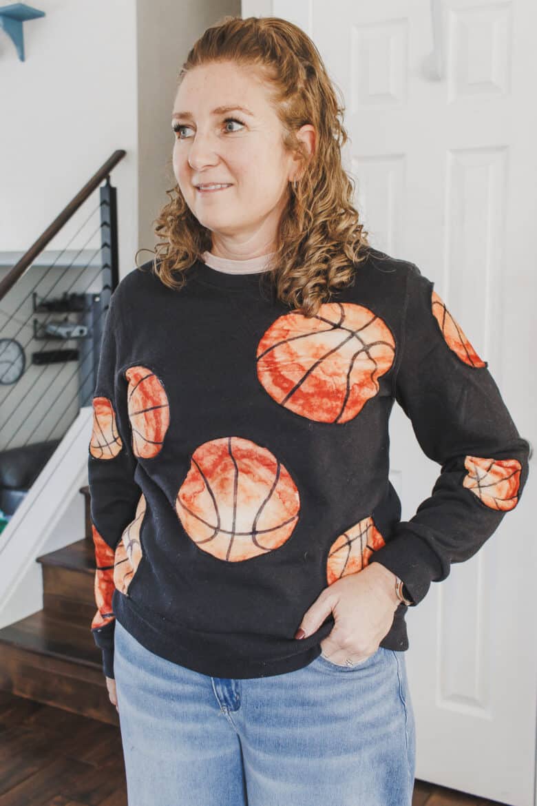 Learn how to create a fun basketball sweatshirt with a mashup of a cozy blanket and  sweatshirt. This Basketball Sweatshirt hack is an easy sewing project. 