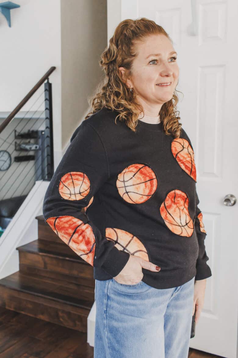 Learn how to create a fun basketball sweatshirt with a mashup of a cozy blanket and  sweatshirt. This Basketball Sweatshirt hack is an easy sewing project. 